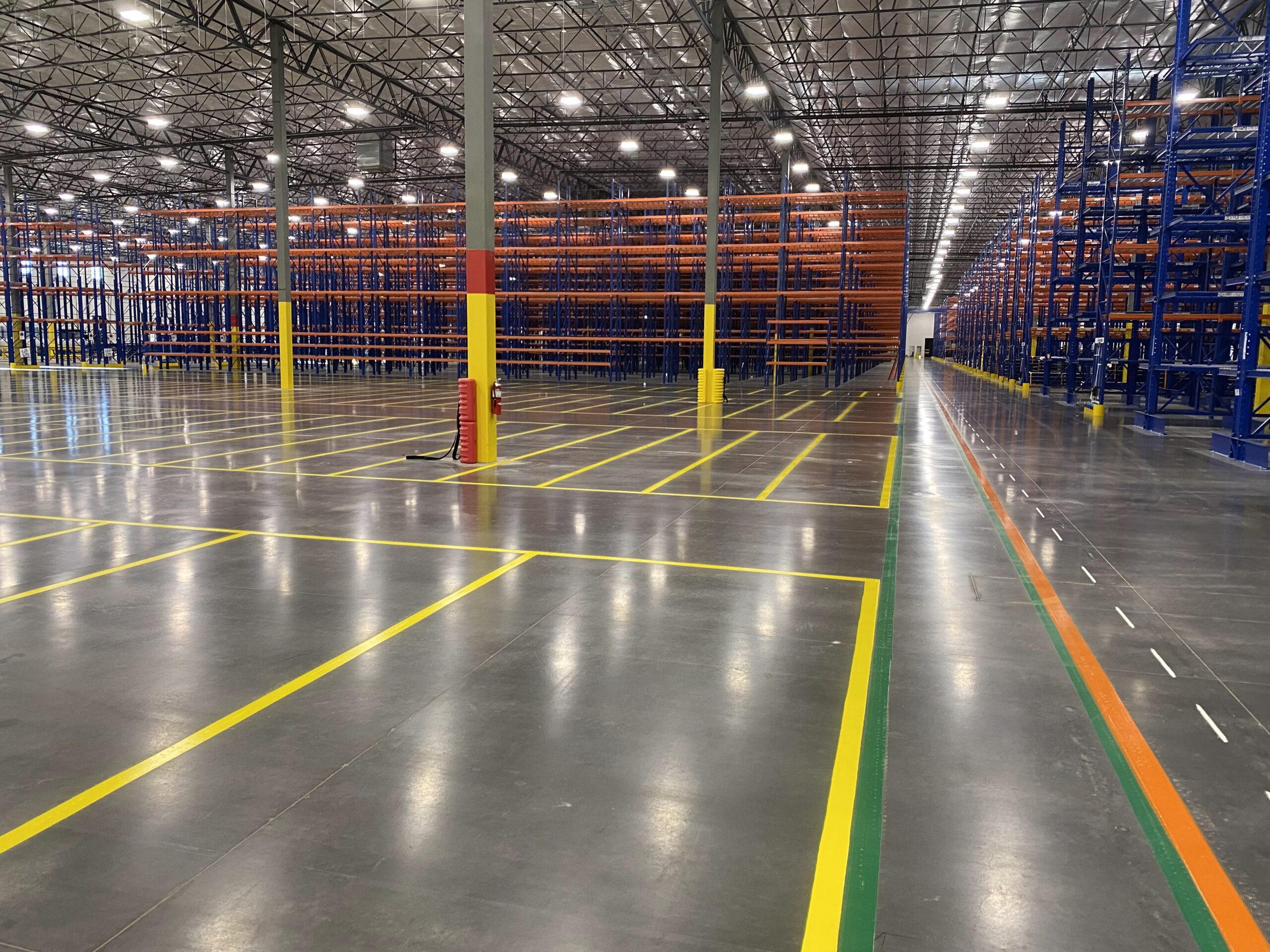 Warehouse safety markings, including forklift lanes and pedestrian zones.”