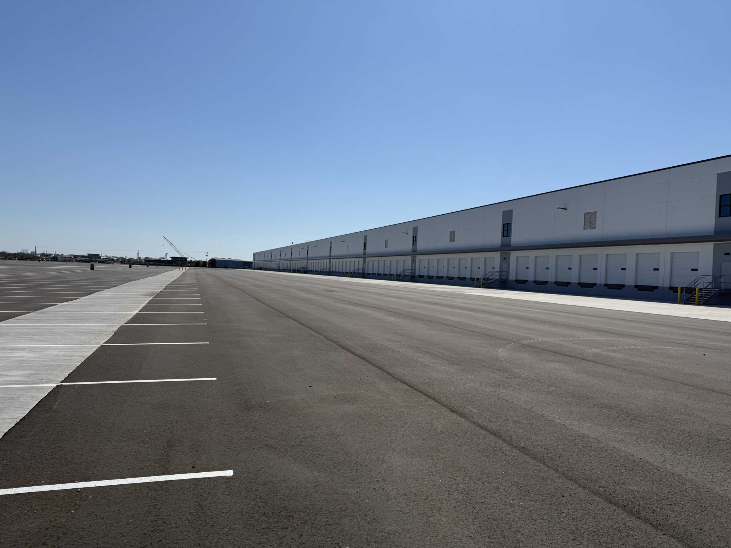 “Warehouse loading dock area with clearly marked line striping for organized truck parking and efficient loading.”