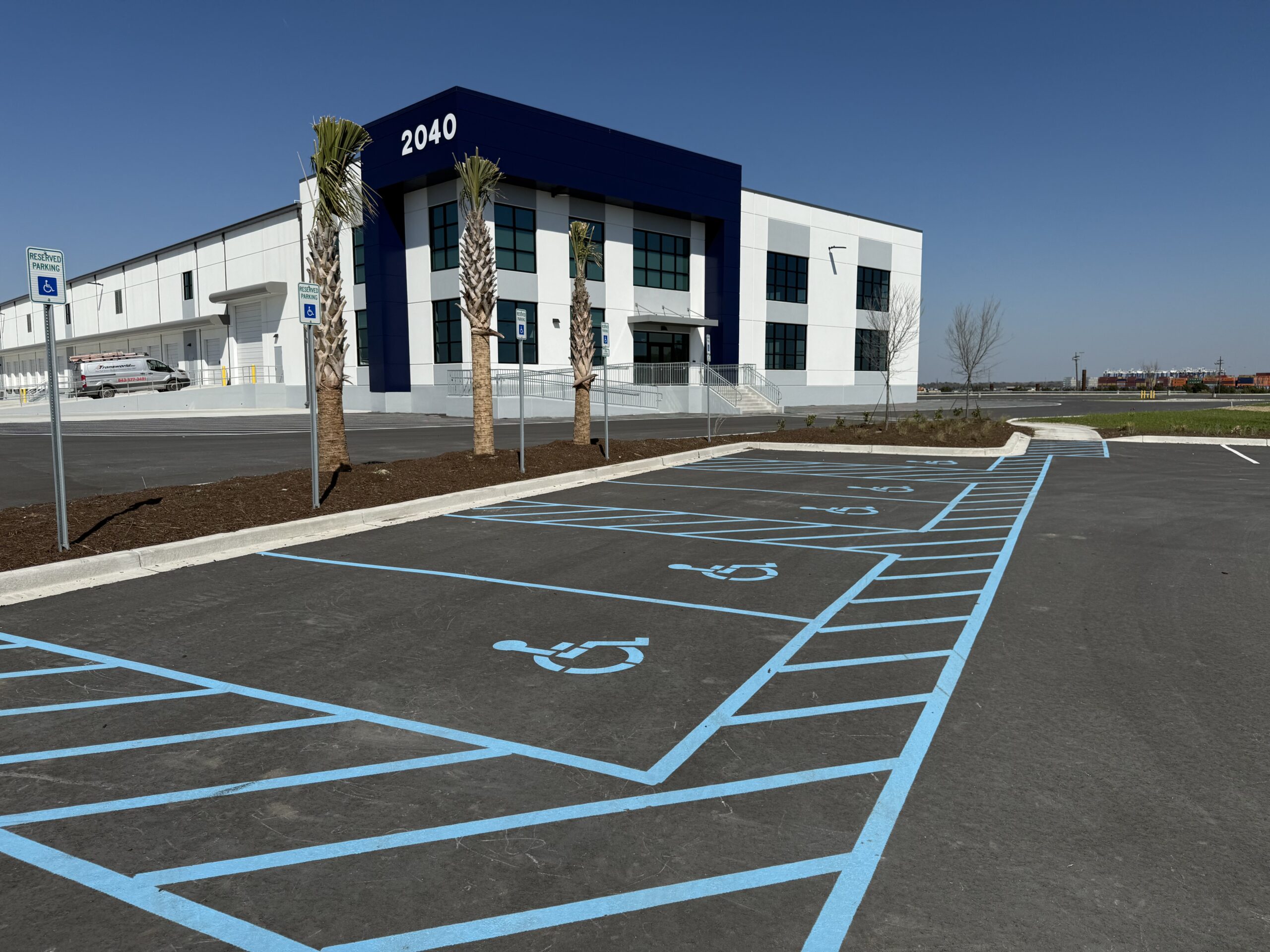 Image of warehouse floor with ADA-compliant markings Alt text: “Warehouse floor with ADA-compliant line striping for accessible pedestrian walkways.”